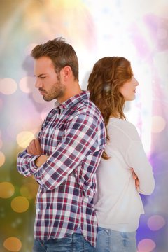 Composite image of depressed couple standing back to back 