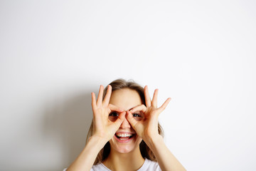 Joyful young woman, sunglasses from finger