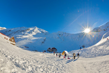 Tourists on the frozen Balea Lake in the Fagaras mountains, Romania