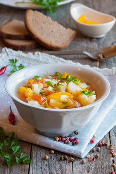 Vegetable soup with bread on wooden table