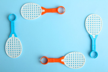 Toy racket in a frame with a blue background