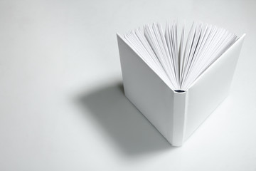 Open empty white book. Top view.