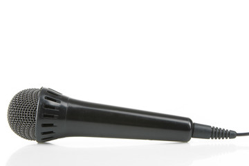 Black musical microphone isolated on a white background.