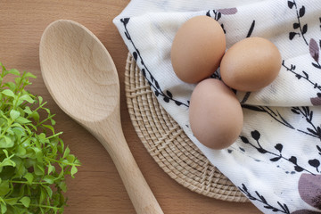 Eggs cooking for breakfast, a protein form yolk and albumen on a white background, or on a plain wooden table.