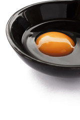Eggs cooking for breakfast, a protein form yolk and albumen on a white background, or on a plain wooden table.