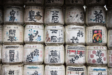 Japanese decorations with japanese inscriptions written inside a buddhist temple. The white colored round shaped designs looks beautifully arranged in a row.