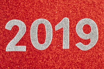 Number two thousand nineteen white over a red background. Annive