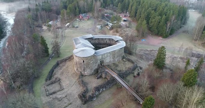 Cinema 4k aerial landing tilit view on Raseborg medieval castle, fortress ruins, at a cloudy autumn day, in Snappertuna, Raasepori, Finland