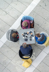 Business meeting at breakfast outdoor, overhead view