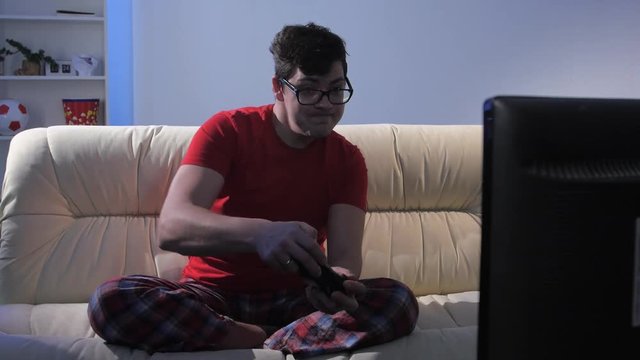 Man rejoices from winning in online game on the console