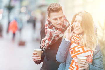 Young beautiful couple having fun in the winter on the street. Couple in love on Valentine's Day