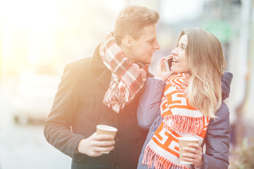 Young beautiful couple having fun in the winter on the street. Couple in love on Valentine's Day