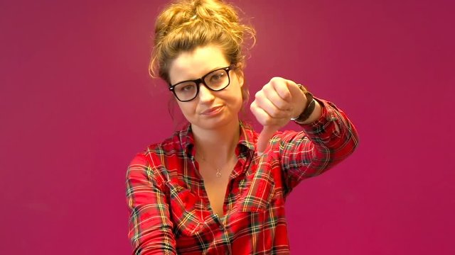 Girl having fiasco and showing thumbs down to the camera, steadycam shot
