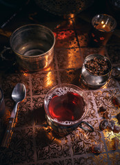 Black tea in cup and candles