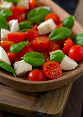 caprese salad on dark wooden surface