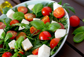 Vegetarian salad with cherry tomato, mozzarella and rucola