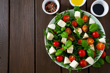 Vegetarian salad with cherry tomato, mozzarella and rucola