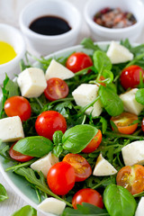 Obraz na płótnie Canvas Vegetarian salad with cherry tomato, mozzarella and rucola
