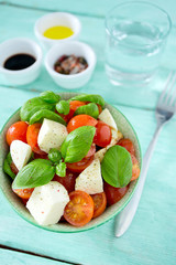 caprese salad on turquoise background