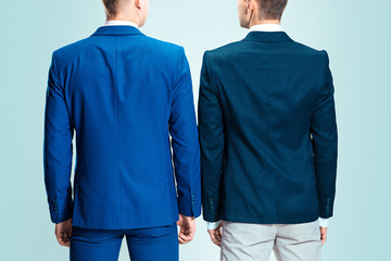 Two young stylish men in a suit. Rear view from the back.