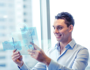 smiling businessman with tablet pc in office
