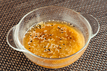 Japanese soup in a transparent bowl on a brown table