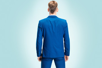 The young stylish man in a suit. Rear view from the back.