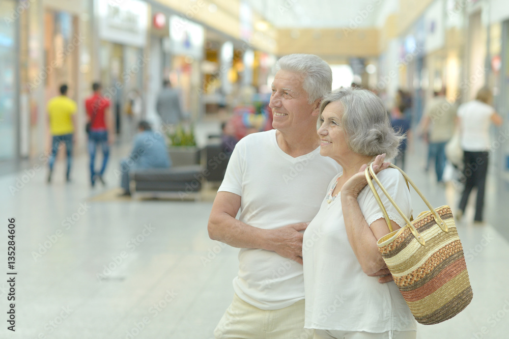 Poster Portrait of beautiful elderly couple in shopping mall