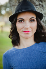 Stylish young woman with black hat