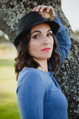 Stylish young woman with black hat