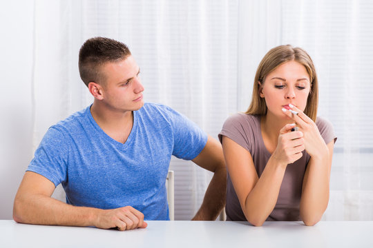 Husband is very sad because his wife doesn't want to stop smoking.

