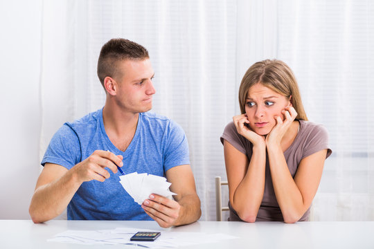 Young couple is having financial problems,husband is angry on his wife because she has spent a lot of money.
