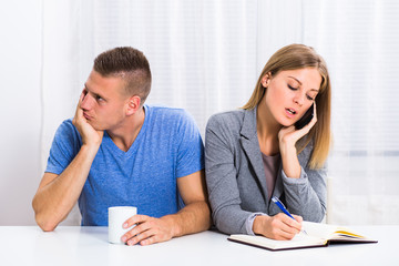 Husband is very sad and he is feeling bored because his wife is thinking of her business all of the time.