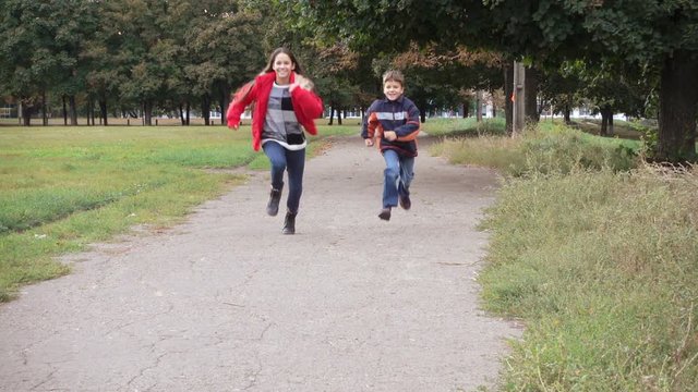 Two kids running on park