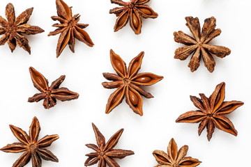 Close-up shot of star anise flat lay pattern isolated on white.