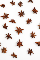 Abstract pattern made of star anise isolated on white, top view, vertical