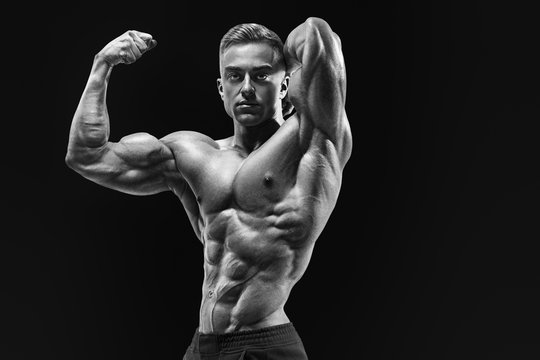 Bodybuilder with muscular physique looking at camera showing bic