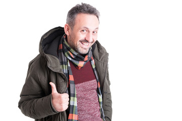 Male posing wearing winter jacket showing thumb up gesture