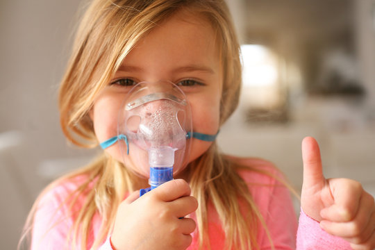 Little Girl Using Inhaler.