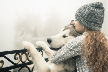 Image of young girl with her dog, alaskan malamute, outdoor