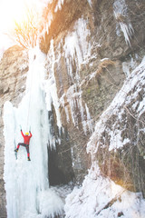 The climber climbs on ice.