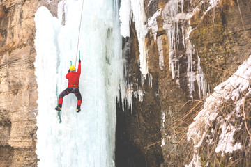 The climber climbs on ice.