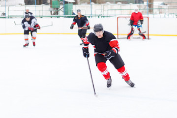 Obraz premium Professional Ice hockey player with stick skating on the rink. Image with copy space