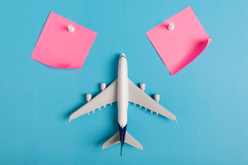Preparation for Traveling concept, paper noted, airplane, push pin, on blue background with copy space.