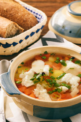 Clear fish soup with vegetables.