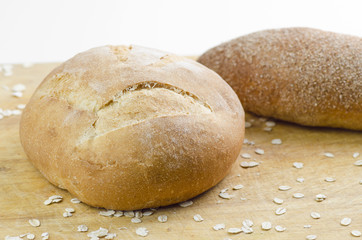 Baked Breads On Wooden Table On White Background Closeup