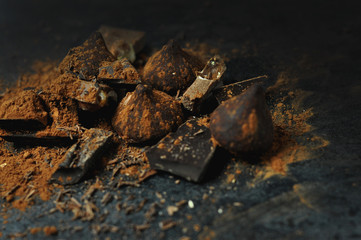 Set of chocolate, truffles and cocoa on rustic background 