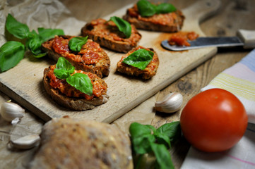 Tasty sandwiches with Bruschetta on wooden board