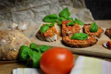 Tasty sandwiches with Bruschetta on wooden board