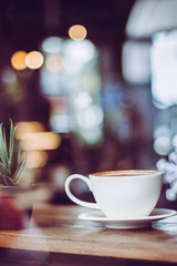 coffee with plant on the wood table